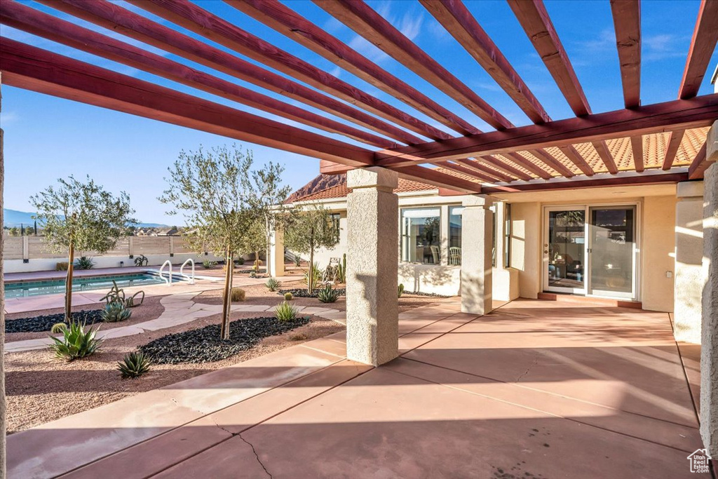 View of patio / terrace featuring a fenced in pool and a pergola