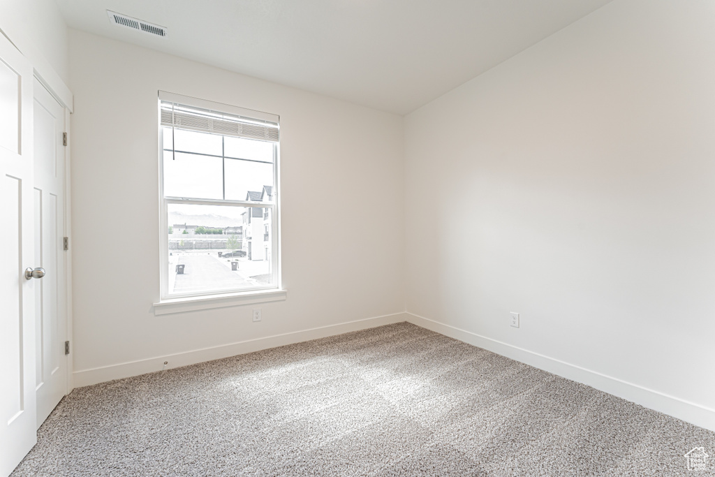 Unfurnished bedroom with baseboards and carpet