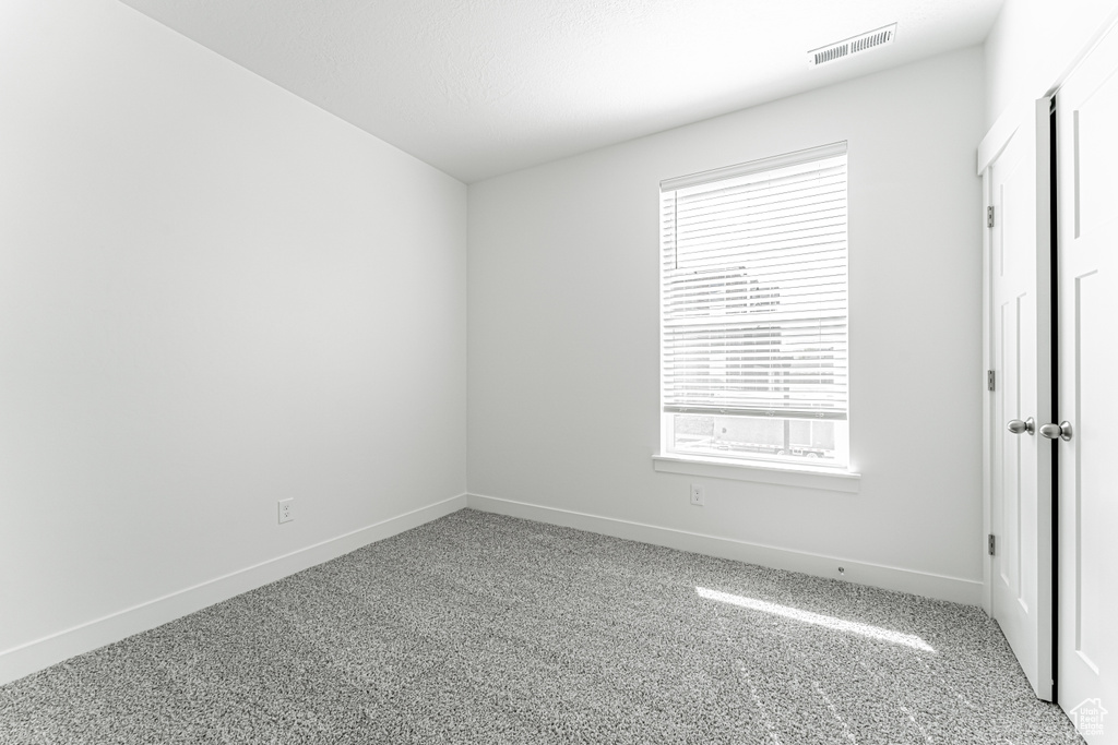 Unfurnished room featuring carpet flooring and baseboards