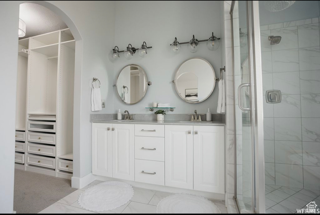 Bathroom featuring vanity and an enclosed shower