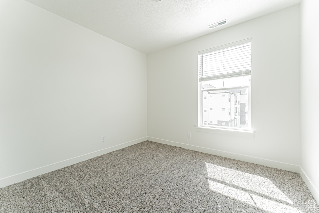 Empty room with baseboards and carpet flooring