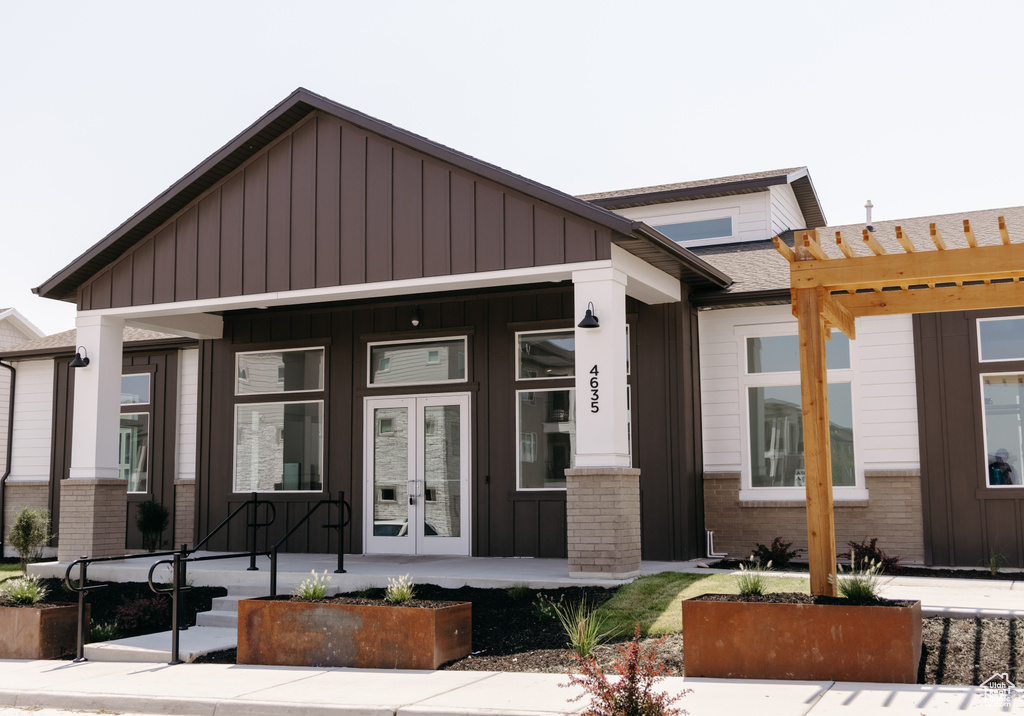 View of front of property with a pergola and french doors