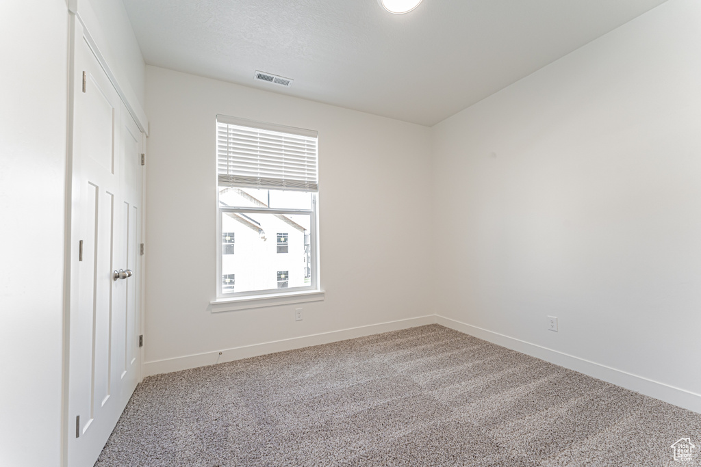 Unfurnished bedroom with baseboards and carpet