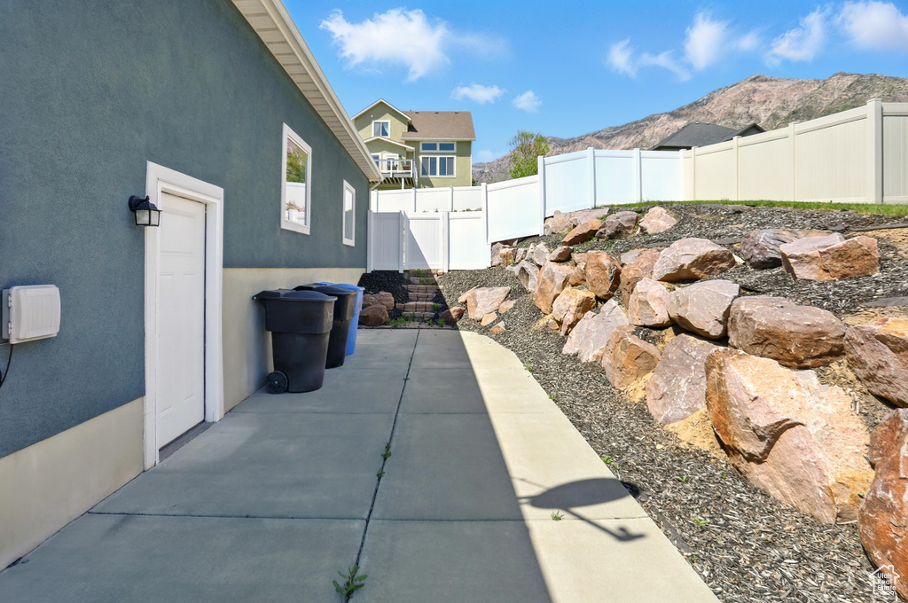 Fenced backyard with a patio and a mountain view