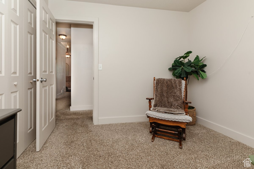 Sitting room featuring light colored carpet