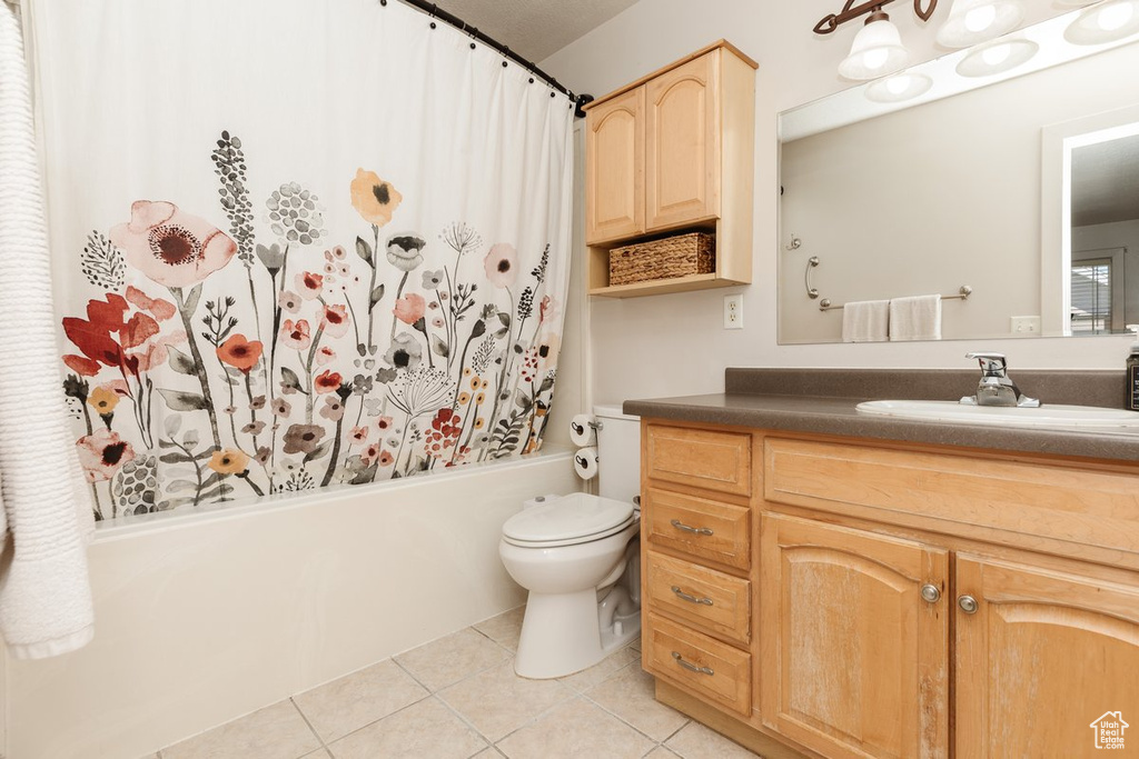 Full bathroom with vanity, tile patterned flooring, toilet, and shower / bathtub combination with curtain