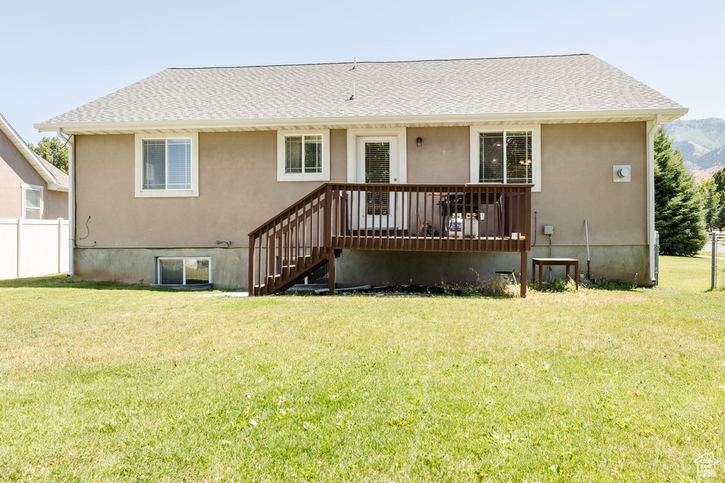 Rear view of property with a lawn