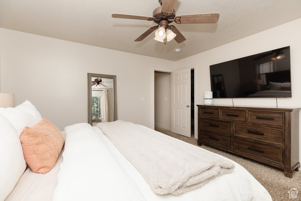 Bedroom with light colored carpet and ceiling fan