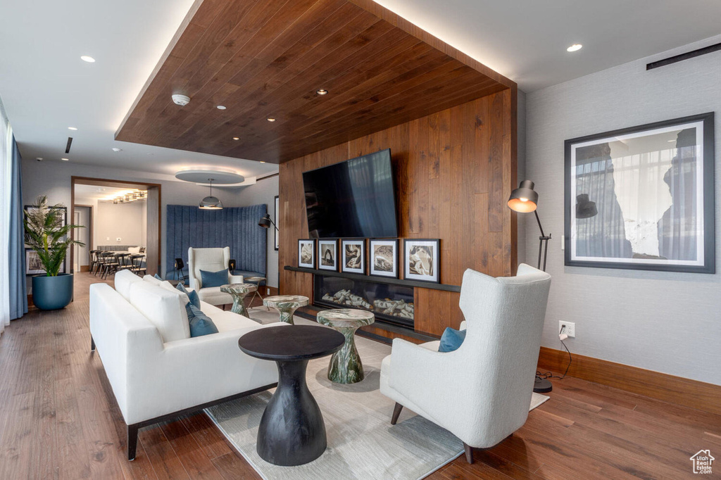 Living room with wooden ceiling and wood-type flooring