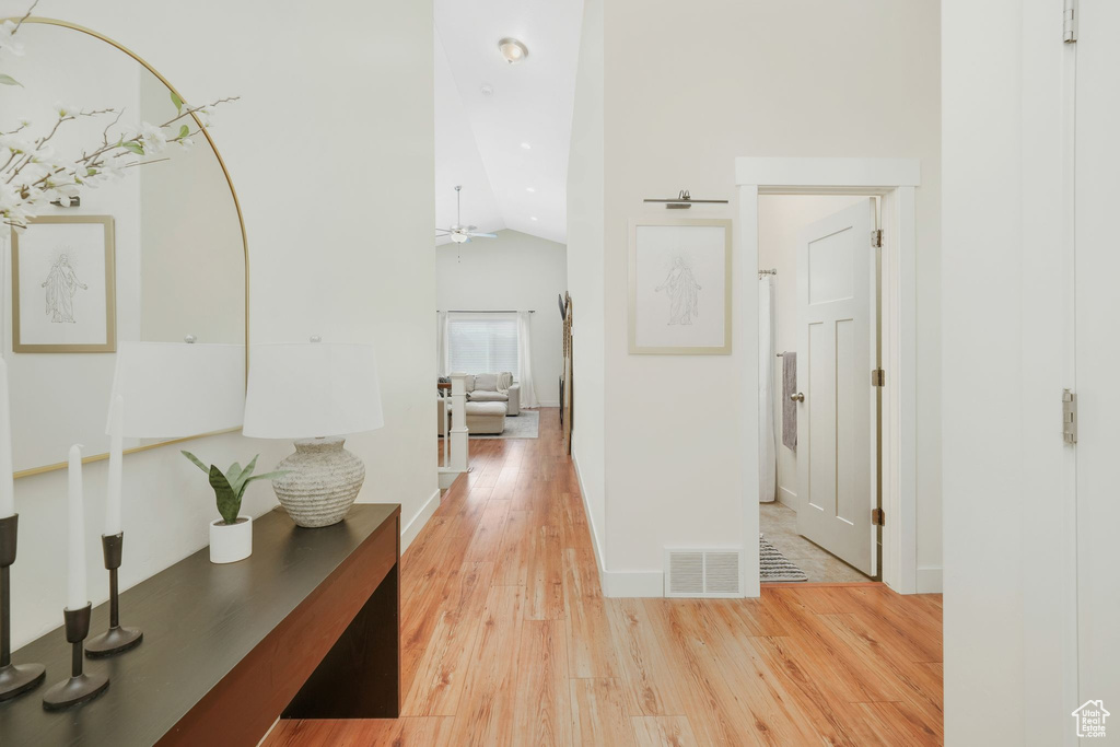Hall featuring lofted ceiling and light wood-type flooring