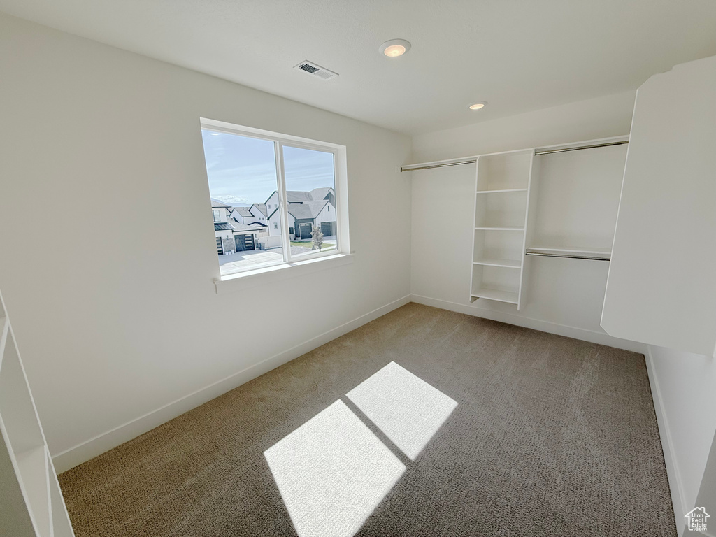 Unfurnished bedroom with light carpet, baseboards, recessed lighting, and a closet