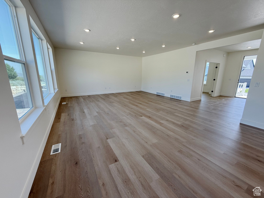 Empty room featuring recessed lighting, light wood finished floors, and baseboards
