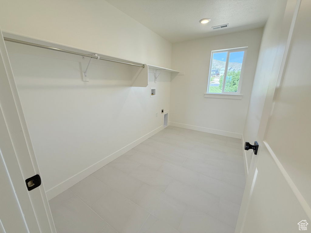 Laundry room with hookup for a washing machine, electric dryer hookup, baseboards, and recessed lighting