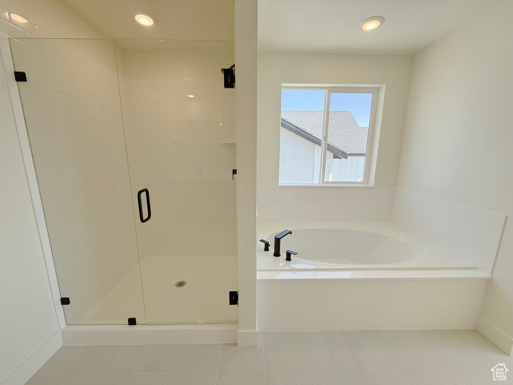 Bathroom featuring a garden tub, a stall shower, tile patterned floors, recessed lighting, and baseboards