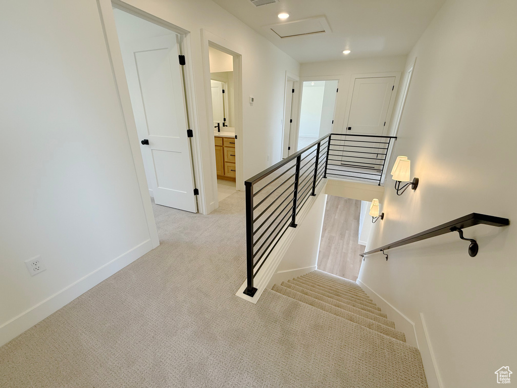 Stairway with carpet flooring, baseboards, recessed lighting, and attic access