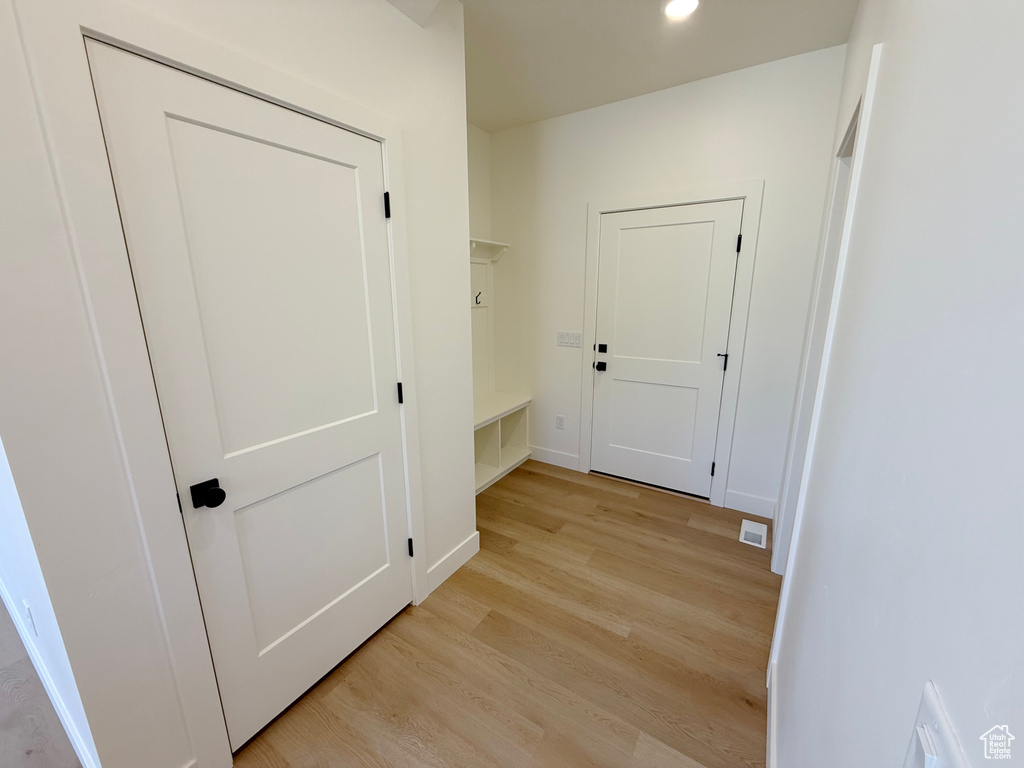 Hallway featuring light wood-style floors