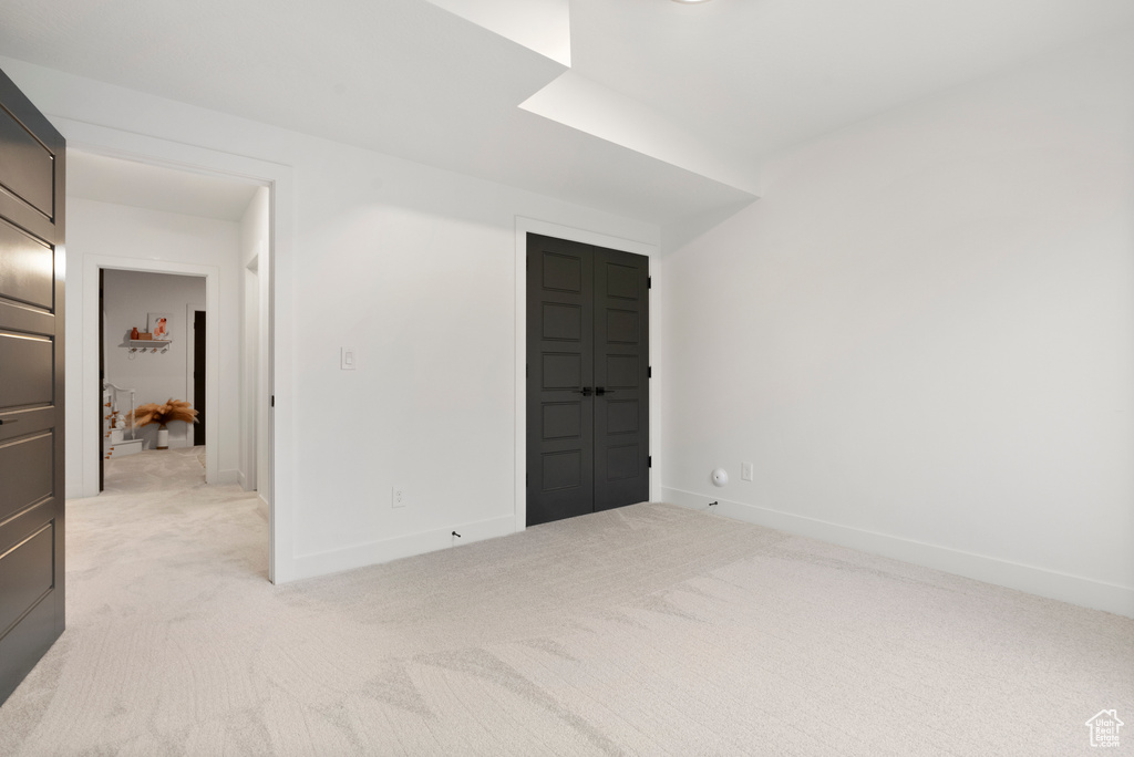 Unfurnished room with light colored carpet