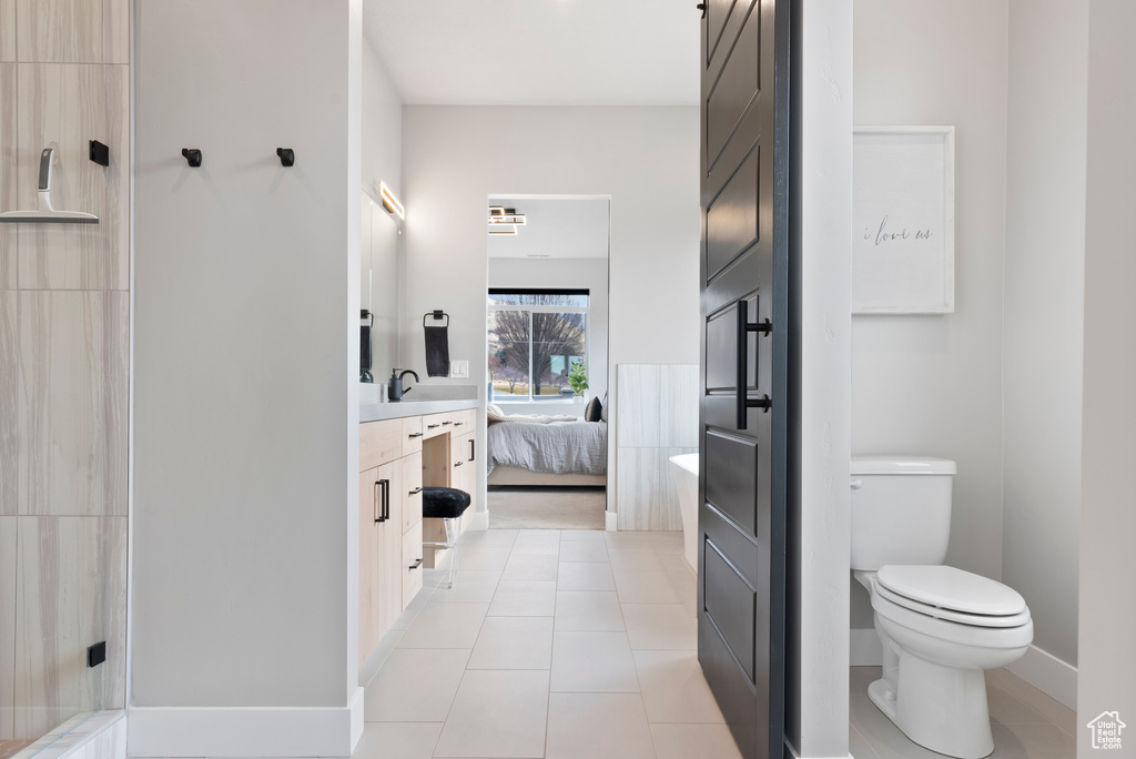 Bathroom featuring tile patterned floors, vanity, and toilet