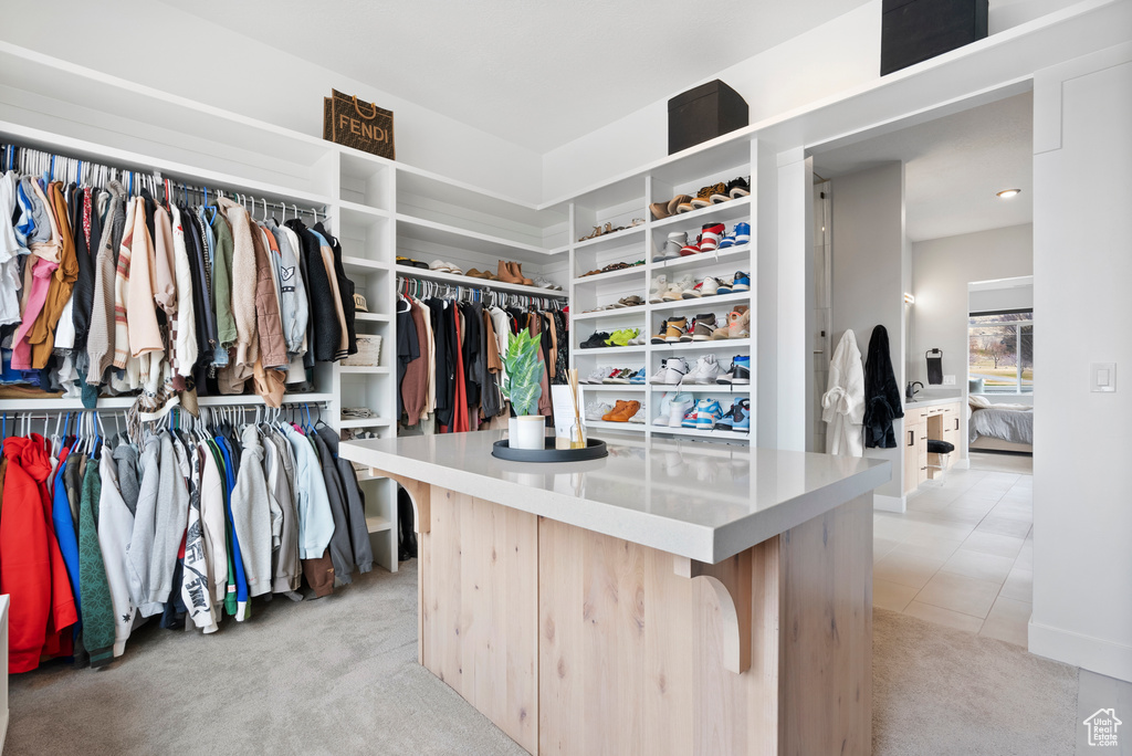 Spacious closet with light carpet