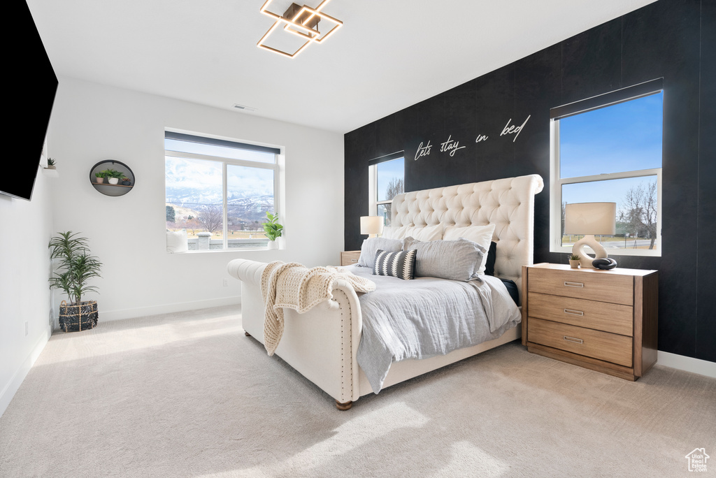 Bedroom with light colored carpet