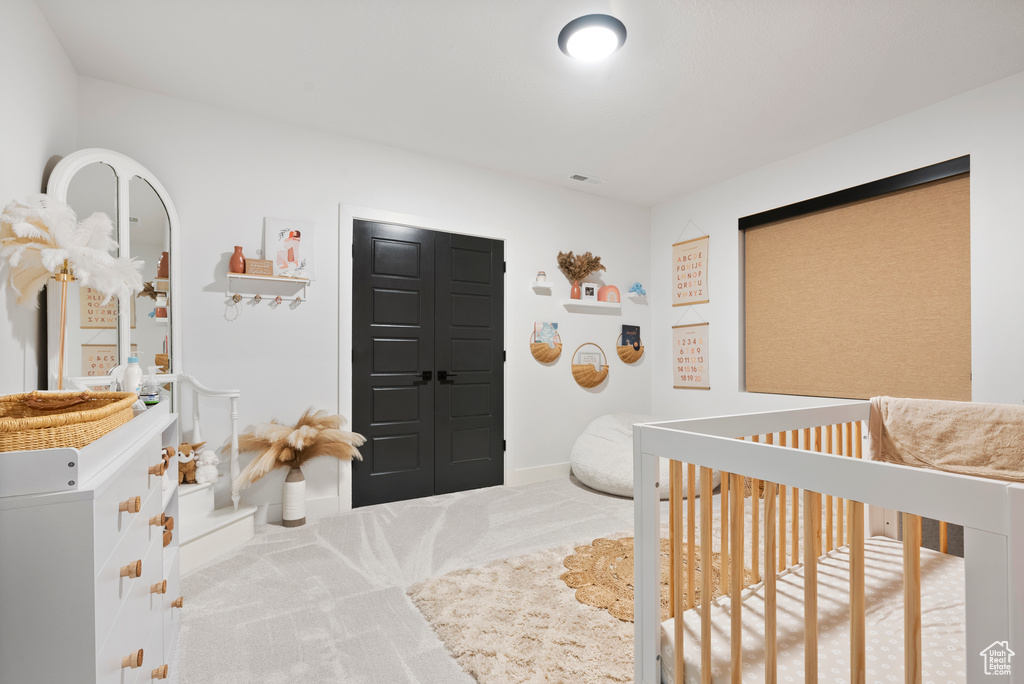 Carpeted bedroom with a nursery area