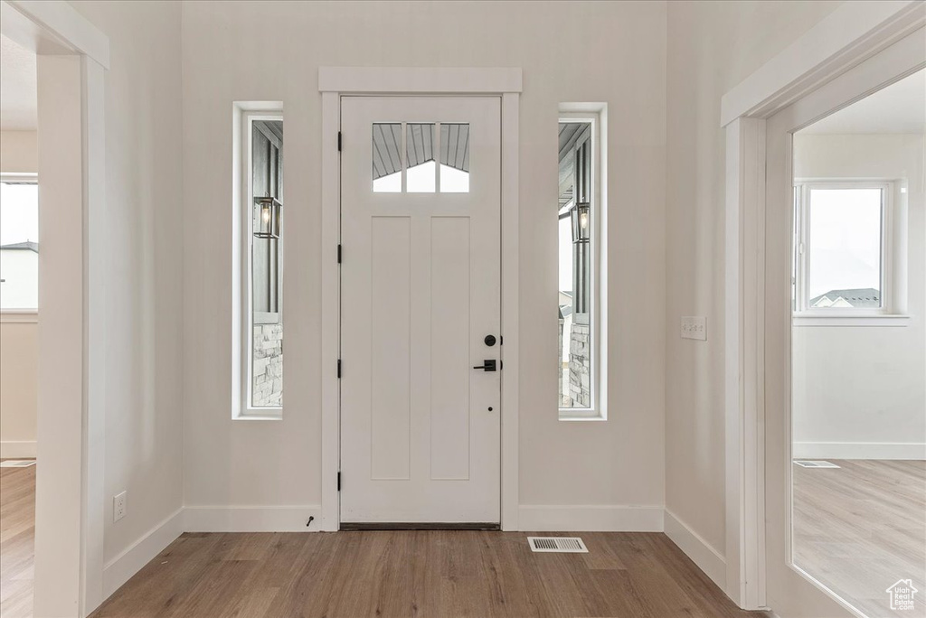 Entryway with light hardwood / wood-style floors