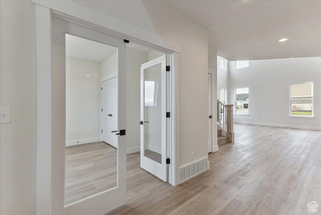 Corridor featuring light wood-type flooring