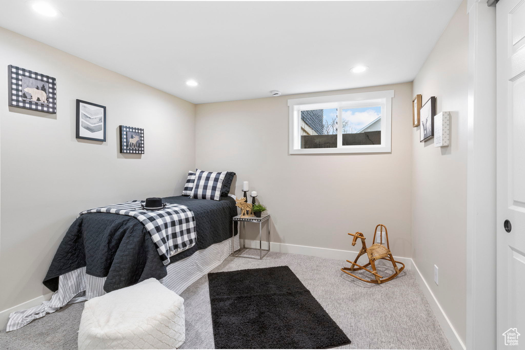 Bedroom featuring light colored carpet