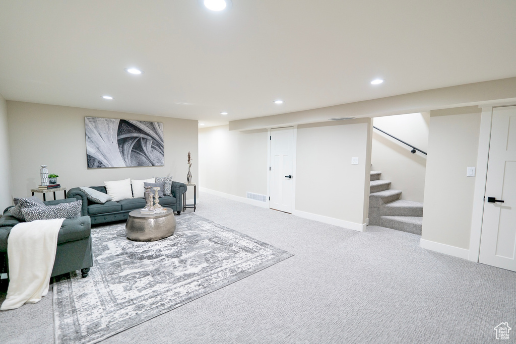 Carpeted living room featuring recessed lighting, visible vents, stairway, and baseboards