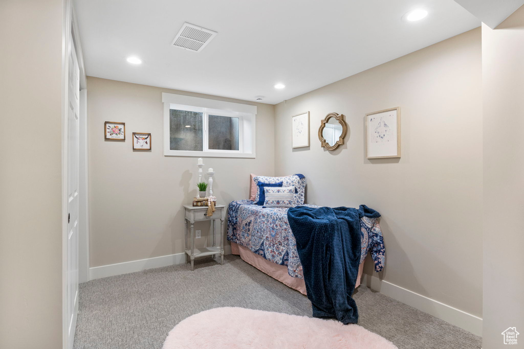 Bedroom featuring light carpet