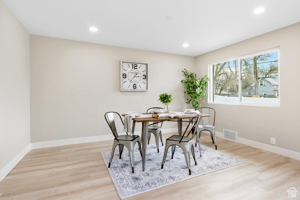 Dining room featuring light wood-style flooring, recessed lighting, visible vents, and baseboards