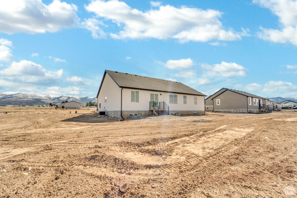 Back of house featuring a mountain view