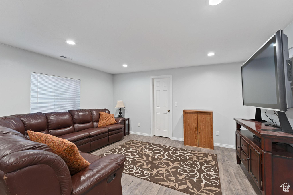 Living room with light hardwood / wood-style floors
