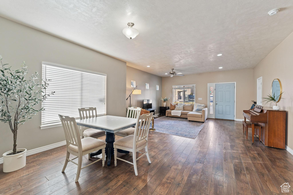 Dining area with dark hardwood / wood-style floors and ceiling fan
