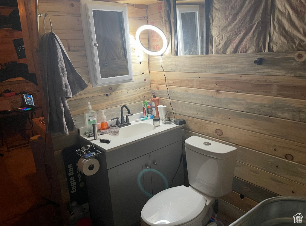 Bathroom featuring wood walls and vanity