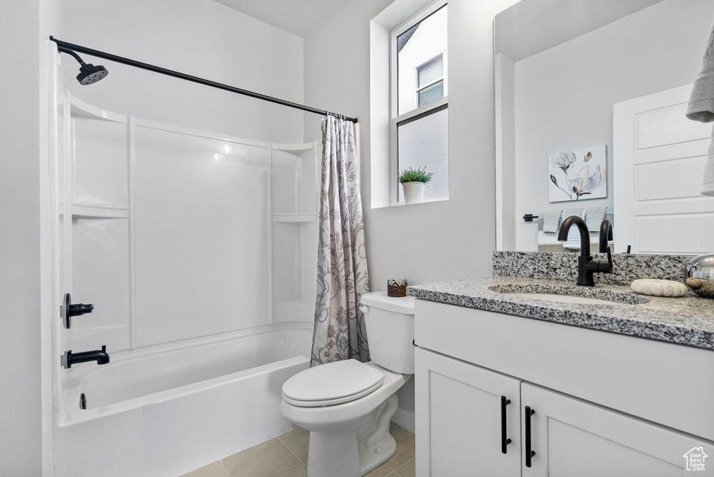 Full bathroom featuring tile patterned flooring, shower / tub combo with curtain, vanity, and toilet