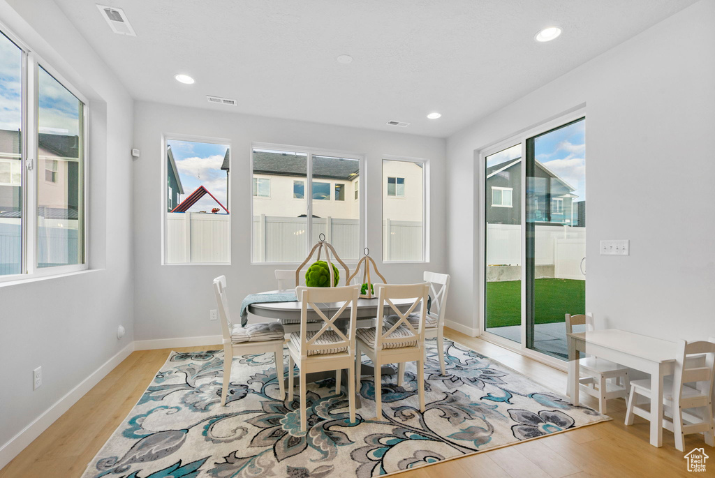 Dining space with light hardwood / wood-style flooring