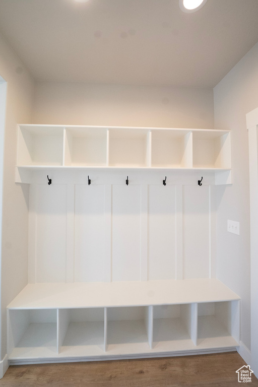 Mudroom featuring wood finished floors and baseboards