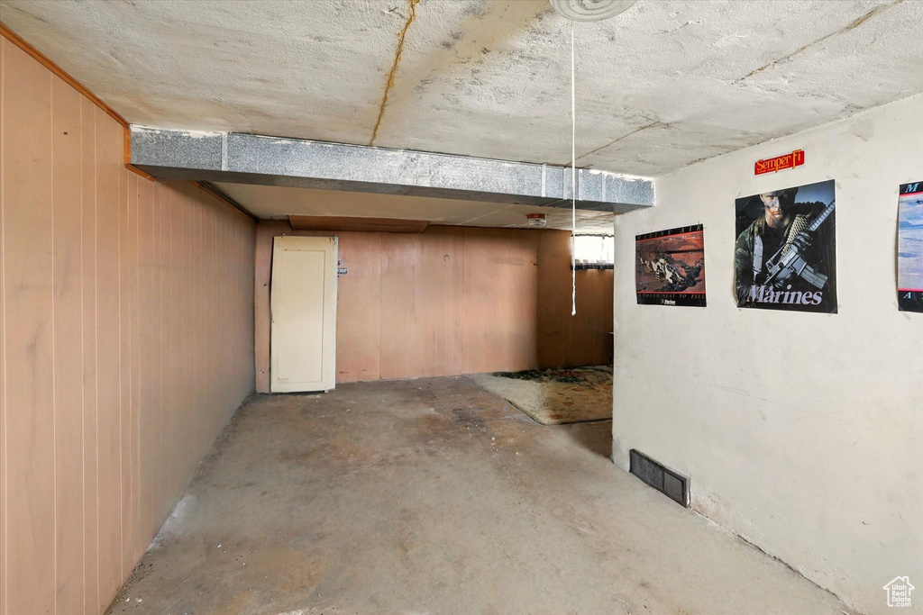 Below grade area featuring wooden walls