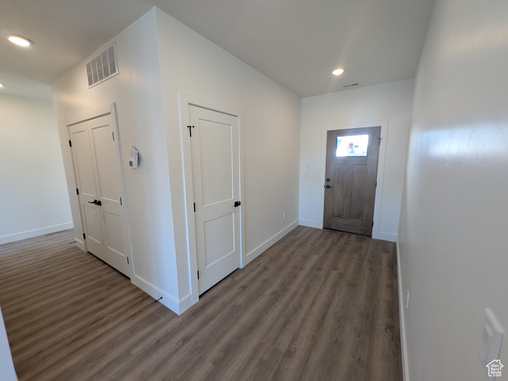 Entryway with dark hardwood / wood-style flooring