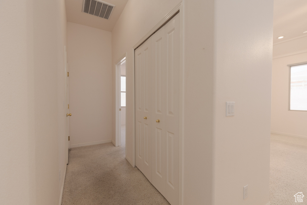 Hall featuring light colored carpet