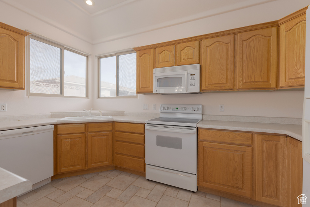 Kitchen with white appliances and sink