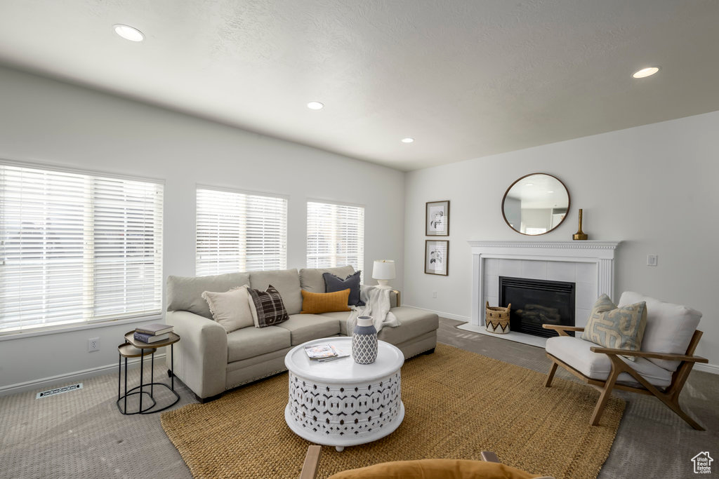 Carpeted living room with a fireplace