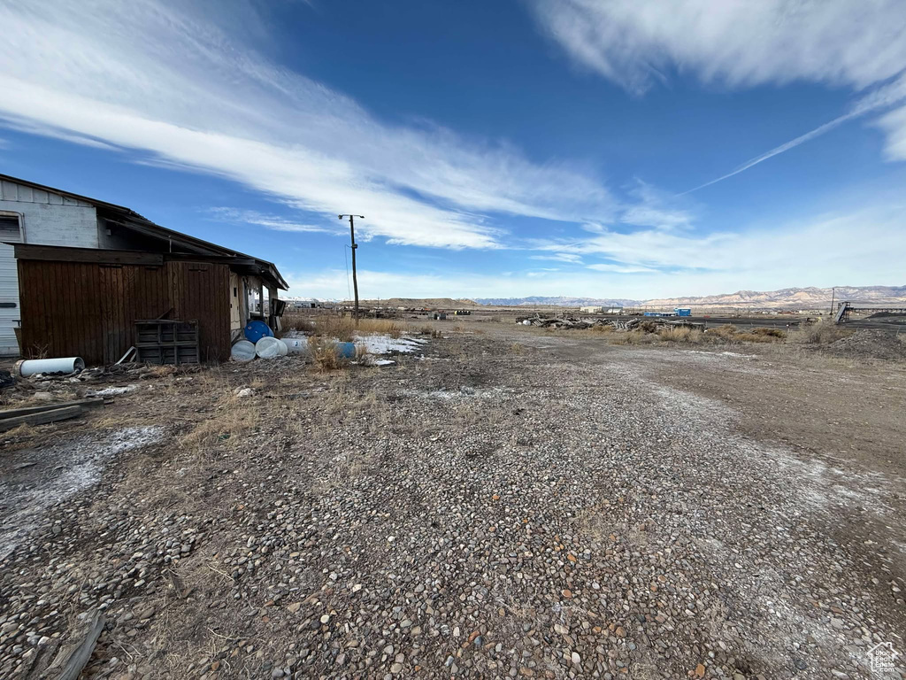 View of yard with an outbuilding and a rural view