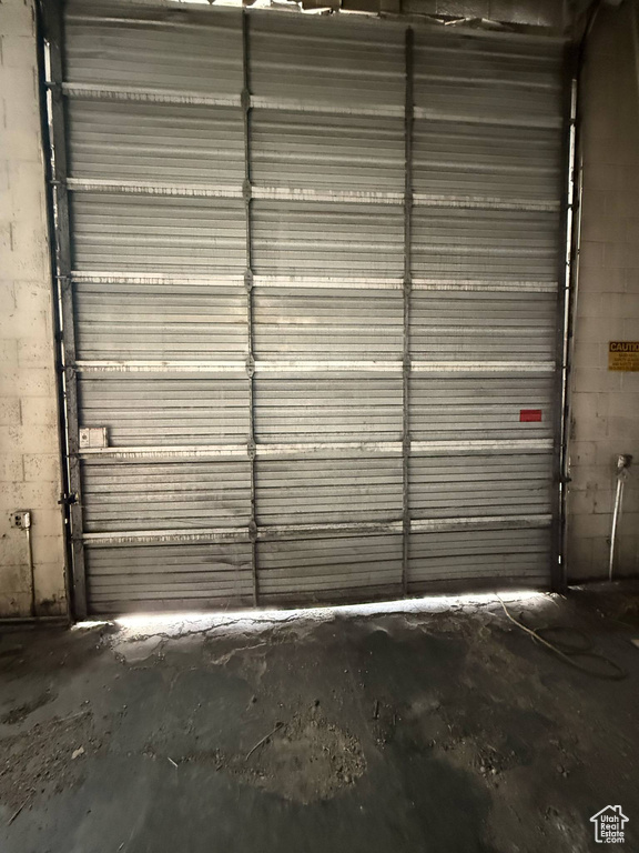 Garage featuring concrete block wall