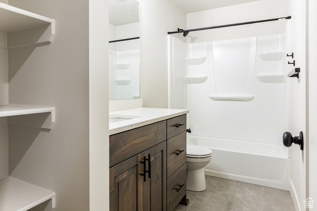Full bathroom with vanity, tile patterned flooring, bathtub / shower combination, and toilet