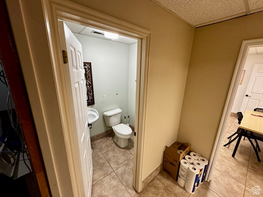 Bathroom with tile patterned flooring, toilet, and sink