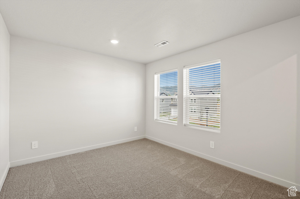 Spare room featuring carpet flooring and recessed lighting