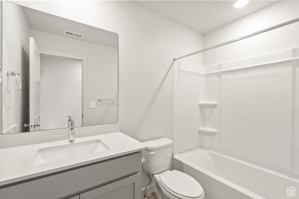 Full bathroom with vanity, bathtub / shower combination, and recessed lighting