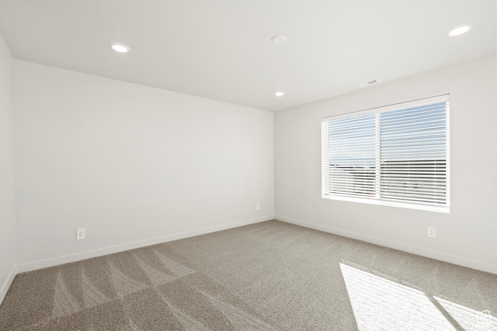 Carpeted spare room with recessed lighting